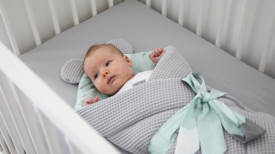 WHAT SHOULD A NEWBORN SLEEP IN?