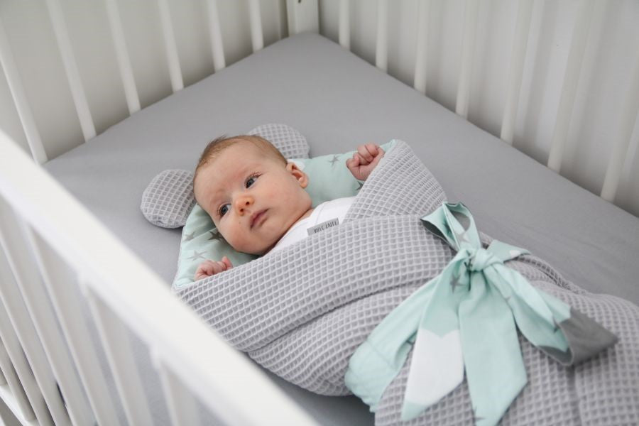 WHAT SHOULD A NEWBORN SLEEP IN?